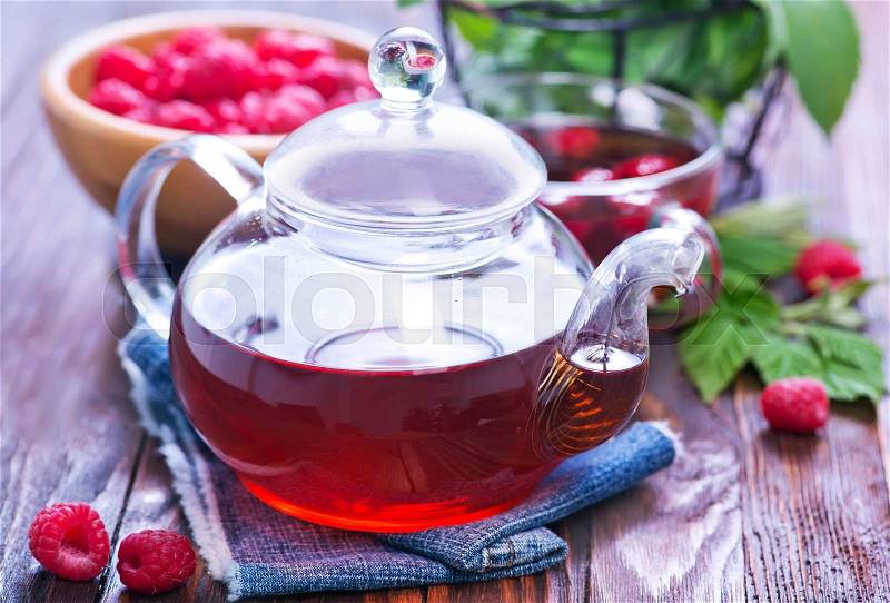 Raspberry tea and fresh berries on a table, stock photo