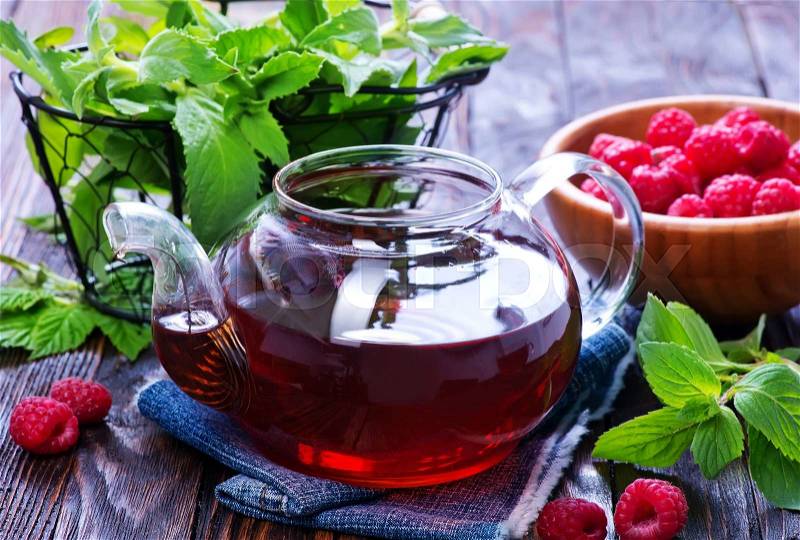 Raspberry tea and fresh berries on a table, stock photo