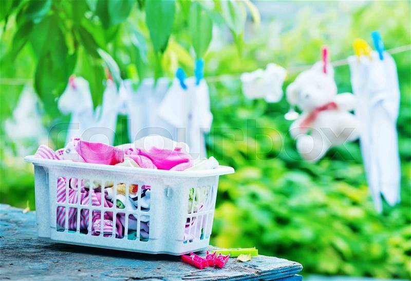 Baby clothes on rope in the garden, stock photo