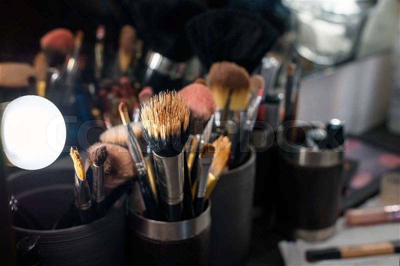 Professional makeup brushes set closeup near salon mirror, stock photo