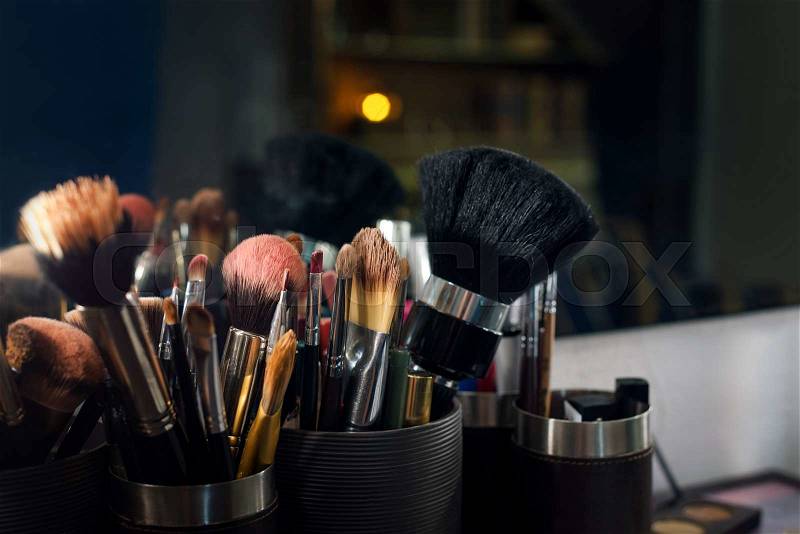 Professional makeup brushes set closeup near salon mirror, stock photo