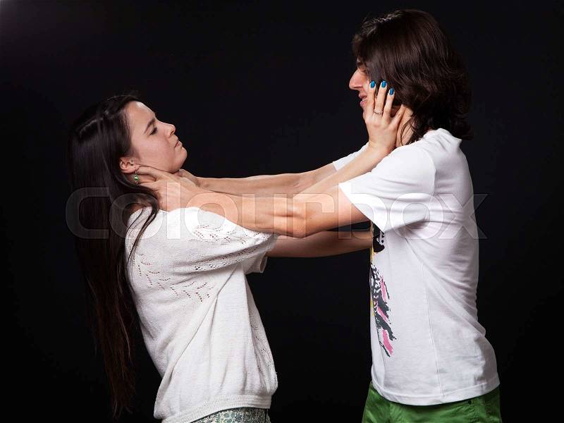 Domestic violence - husband and wife are fighting, black background, stock photo