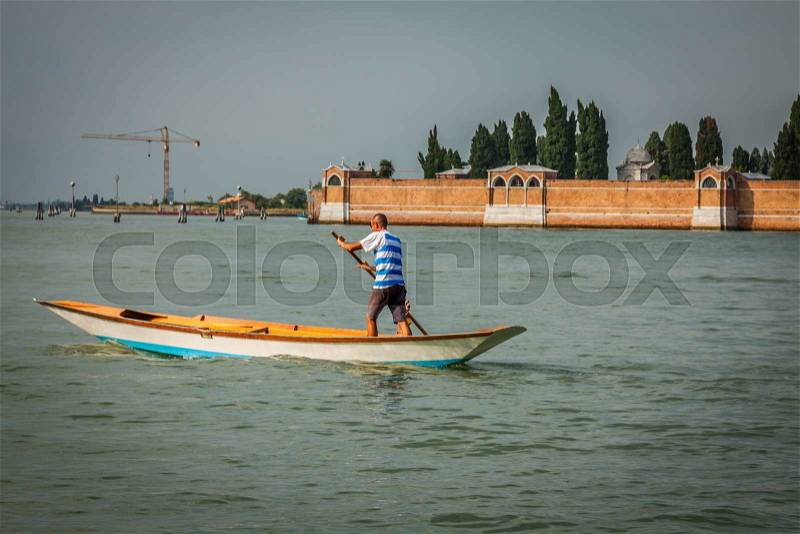 The man on the boat Venice, Italy, stock photo