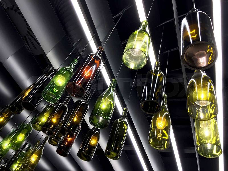 Magnificent retro light lamp decor made of wine bottles. Toned, stock photo