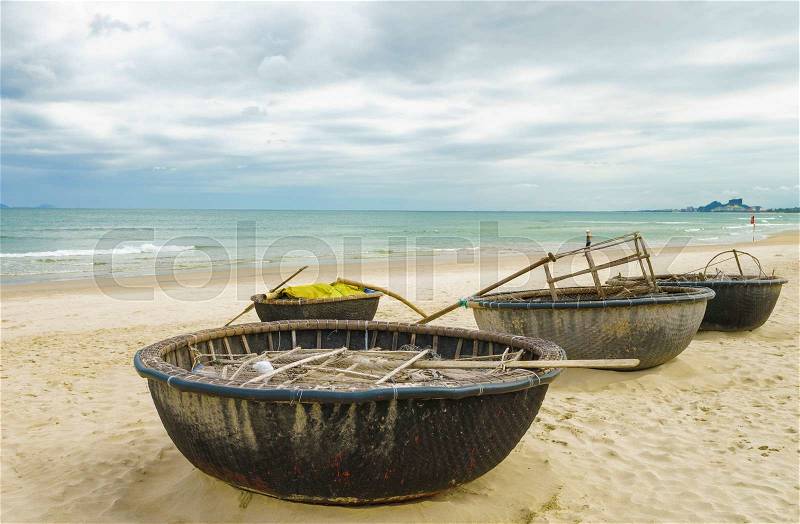 Bamboo waterproof round fishing boats at the China Beach in Danang in Vietnam. It is also called Non Nuoc Beach. South China Sea on the background, stock photo