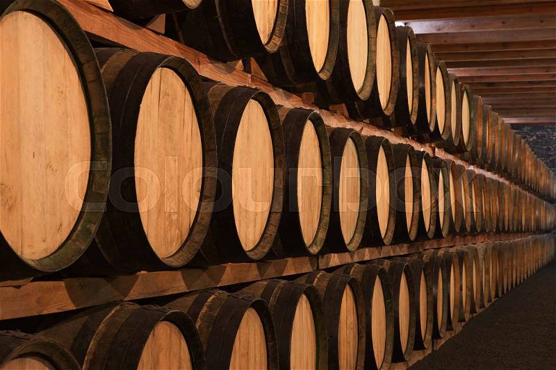 Wine barrels in wine cellar in order, stock photo