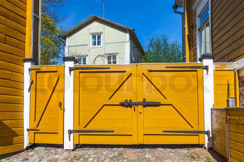 Porvoo, Finland. Old Finnish town street view. Closed yellow wooden gate, stock photo