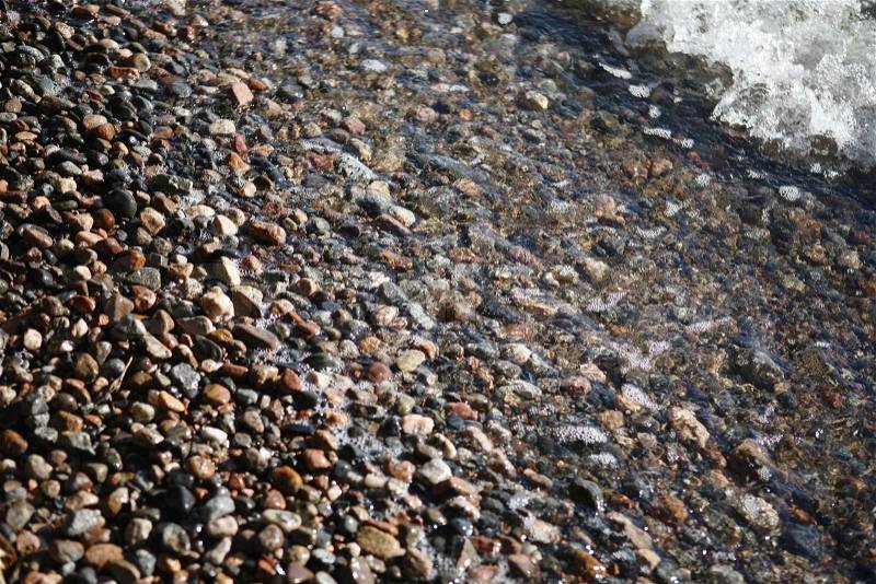 Small stones at seashore, stock photo
