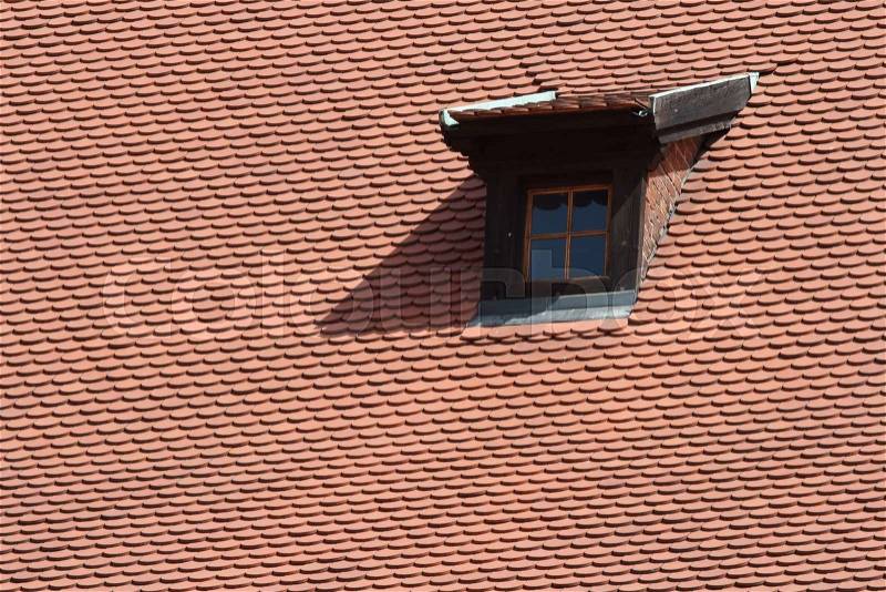 Mansard window in old tiled roof closeup , stock photo