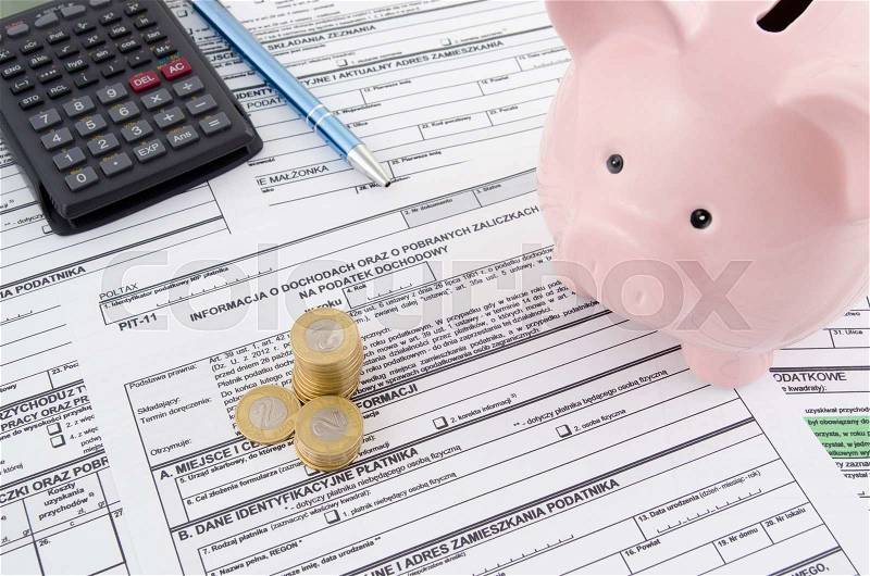 Polish income tax forms with calculator and piggybank, stock photo