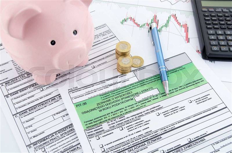 Polish income tax forms with calculator and piggybank, stock photo