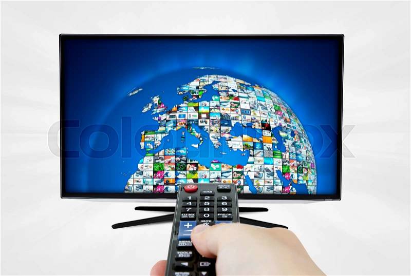 Widescreen high definition TV screen with sphere video gallery. Remote control in hand, stock photo