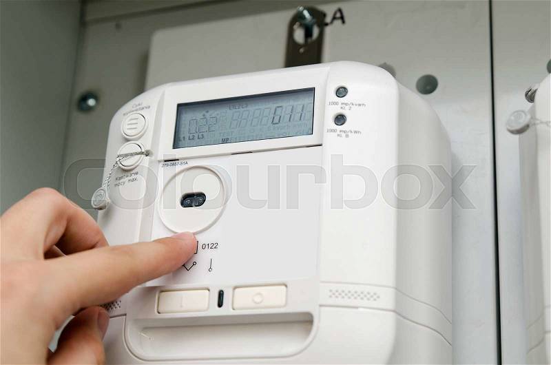 Electric energy meter. Electrical technician servicing unit, stock photo