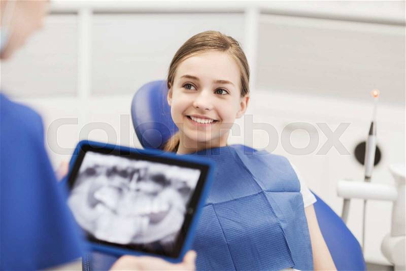 People, medicine, stomatology, technology and health care concept - dentist with x-ray on tablet pc computer and girl patient, stock photo