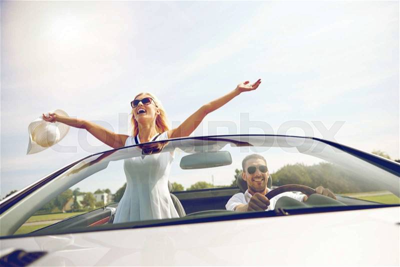 Road trip, travel, dating, couple and people concept - happy man and woman driving in cabriolet car outdoors, stock photo