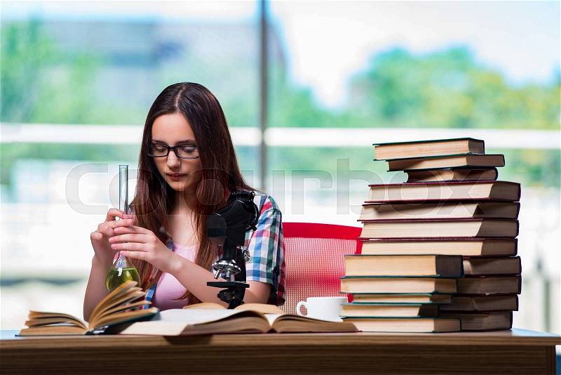 Female student preparing for chemistry exams, stock photo