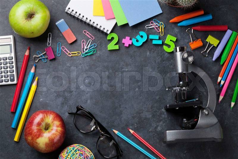 Supplies over chalk board for your text. Back to school concept with copy space, stock photo