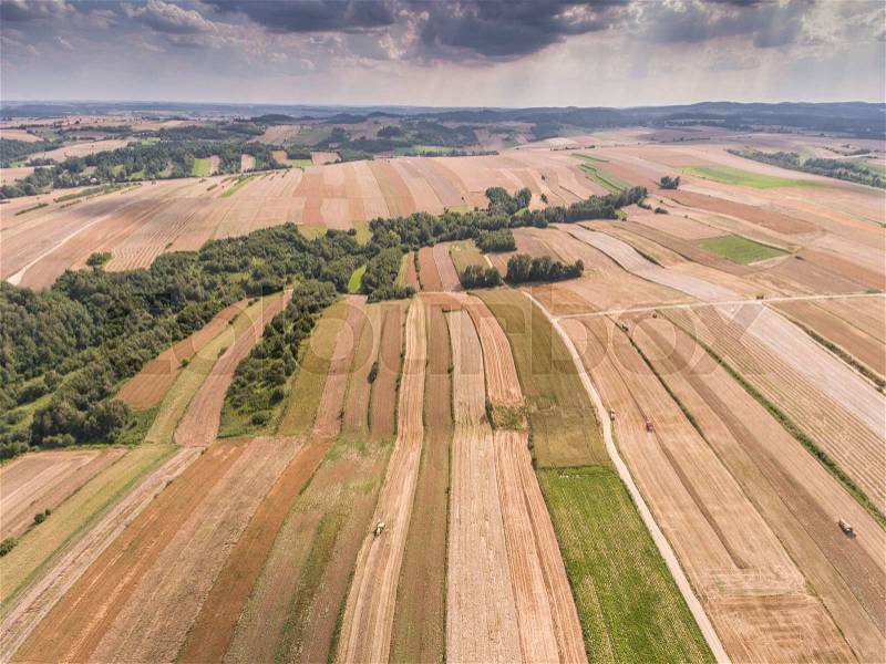 Aerial view of the blue sky and village harvest fields at summer time in Poland, stock photo