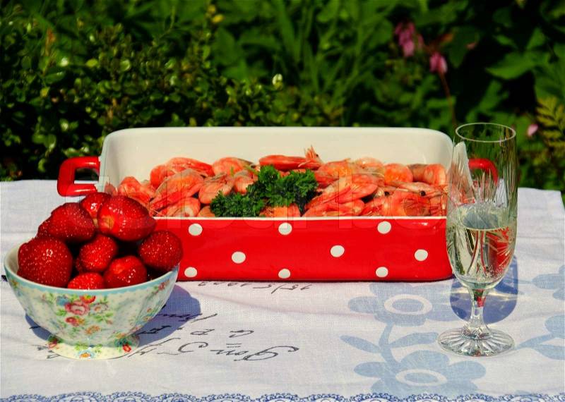 Serving summer food, scrimps, strawberries and white wine, stock photo