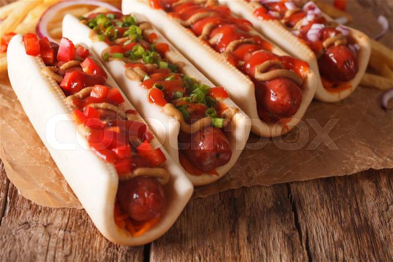 Fast food: hot dogs close-up on a paper on the table. horizontal , stock photo