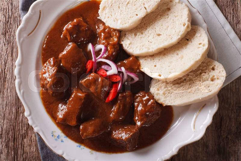 Czech Food: Traditional goulash with knedle on the table close-up. horizontal view from above , stock photo