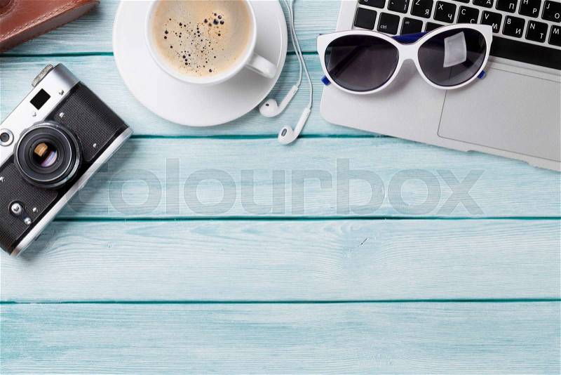 Desk with laptop, coffee and camera on wooden table. Workplace. Top view with copy space, stock photo
