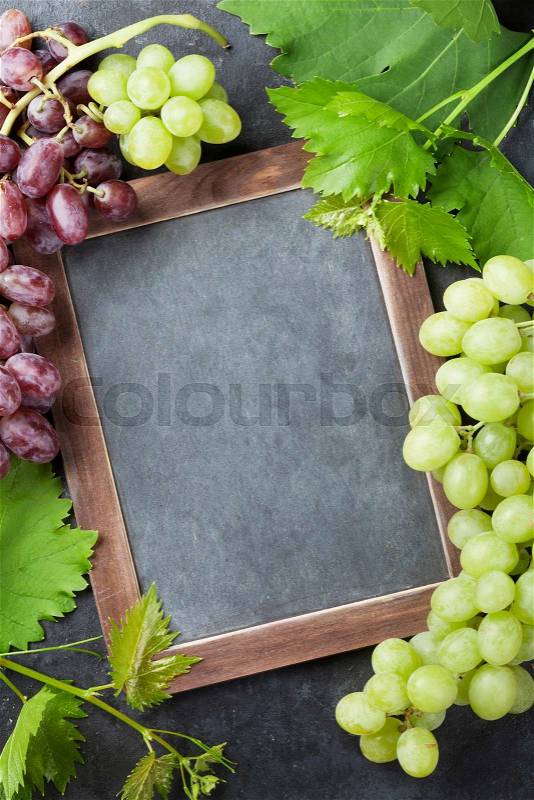 Red and white grapes and chalkboard for your text. Top view with copy space, stock photo