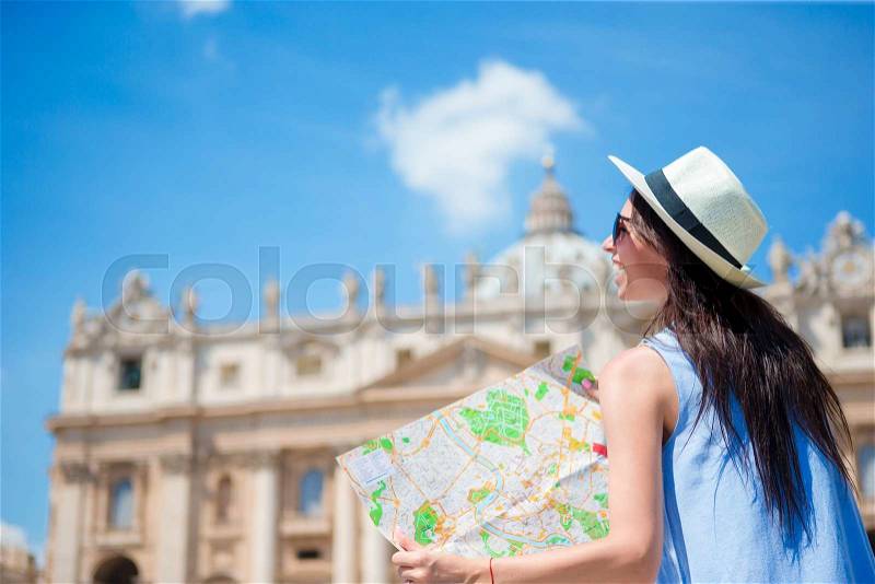 Happy young woman with city map in Vatican city and St. Peter\'s Basilica church, Rome, Italy. Travel tourist woman with map outdoors during holidays in Europe, stock photo