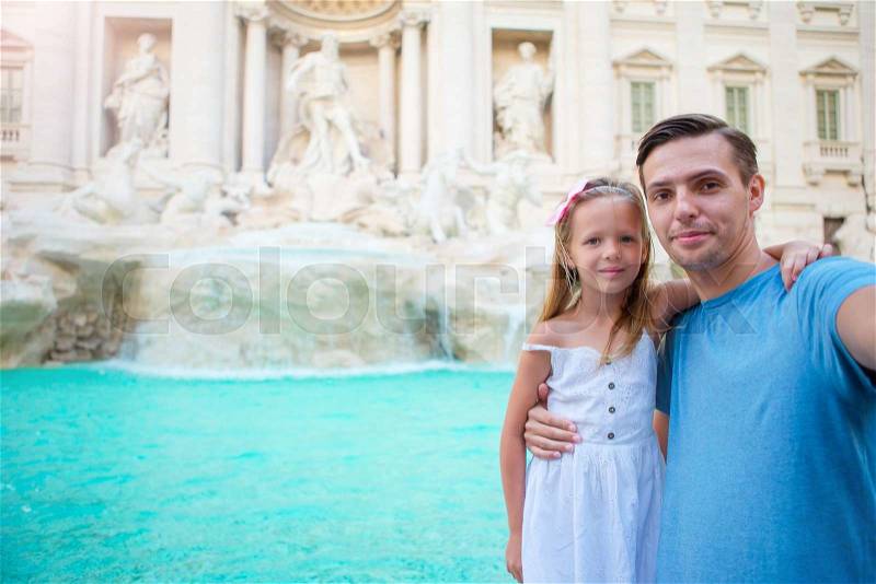 Young father and little girl making selfie in Coliseum, Rome, Italy. Family portrait at famous places in Europe, stock photo