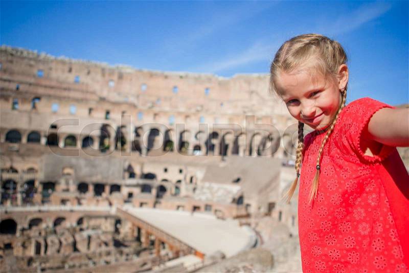 Little girl making selfie in Coliseum, Rome, Italy. Kid portrait at famous places in Europe, stock photo