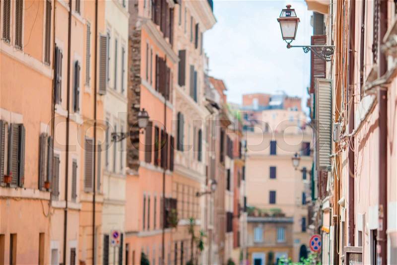 Old beautiful empty streets in Rome, Italy. Close-up of a street light at the town house, stock photo