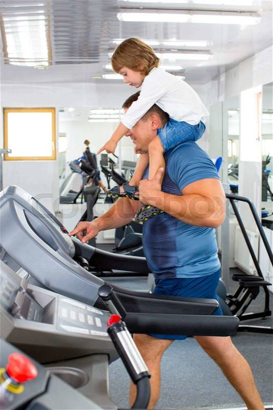 Father and son do sports in the gym, stock photo