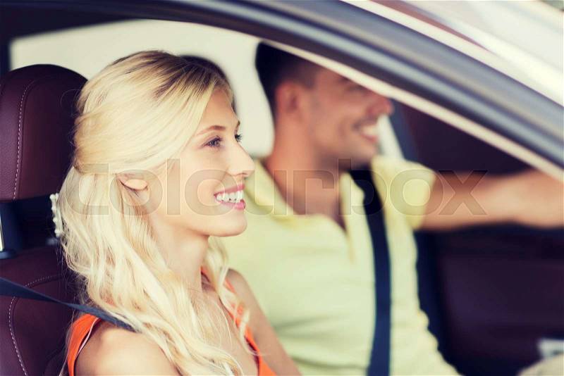 Transport, leisure, road trip and people concept - happy man and woman driving car, stock photo