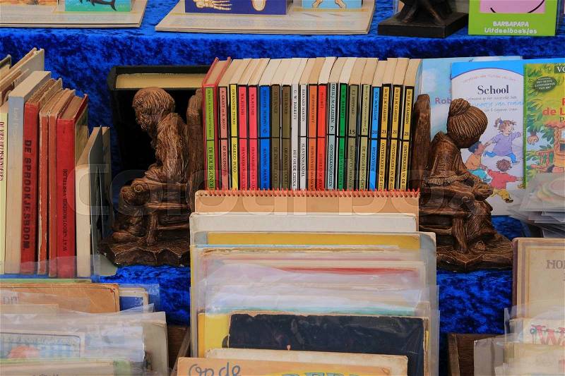 Two bookends, an old man and an old woman between the books at the yearly book market in the city Deventer in the summer, stock photo