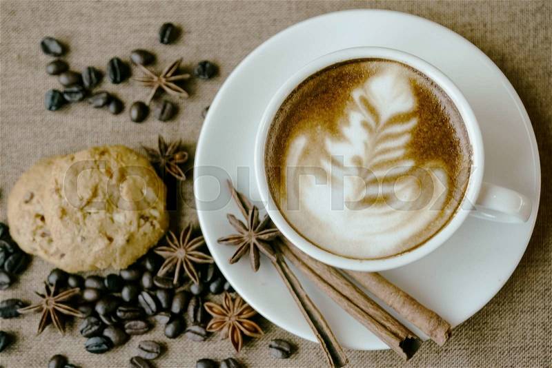 Cup of coffee and cookie in coffee shop vintage color, stock photo