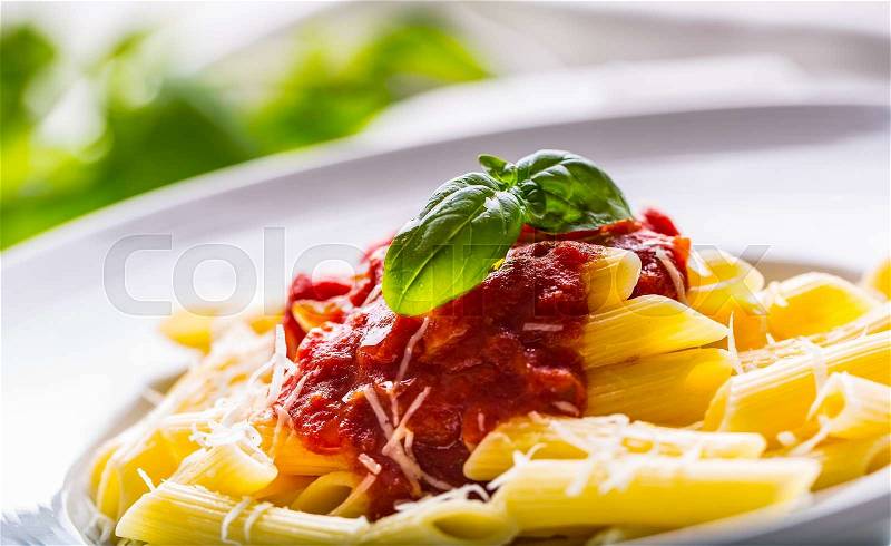 Pasta Penne with Tomato Bolognese Sauce, Parmesan Cheese and Basil. Mediterranean food.Italian cuisine, stock photo