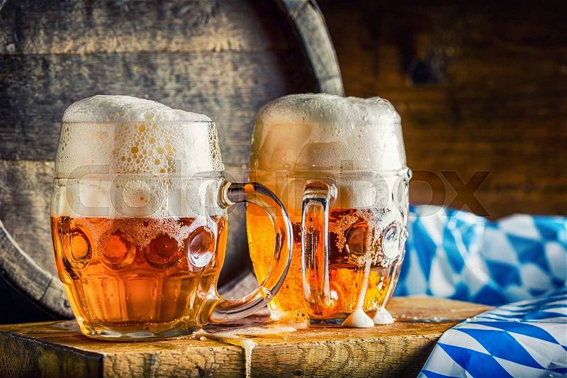 Beer. Oktoberfest.Two cold beers. Draft beer. Draft ale. Golden beer. Golden ale. Two gold beer with froth on top. Draft cold beer in glass jars in pub hotel or restaurant. Still life, stock photo