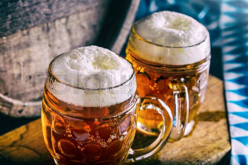 Beer. Oktoberfest.Two cold beers. Draft beer. Draft ale. Golden beer. Golden ale. Two gold beer with froth on top. Draft cold beer in glass jars in pub hotel or restaurant. Still life, stock photo