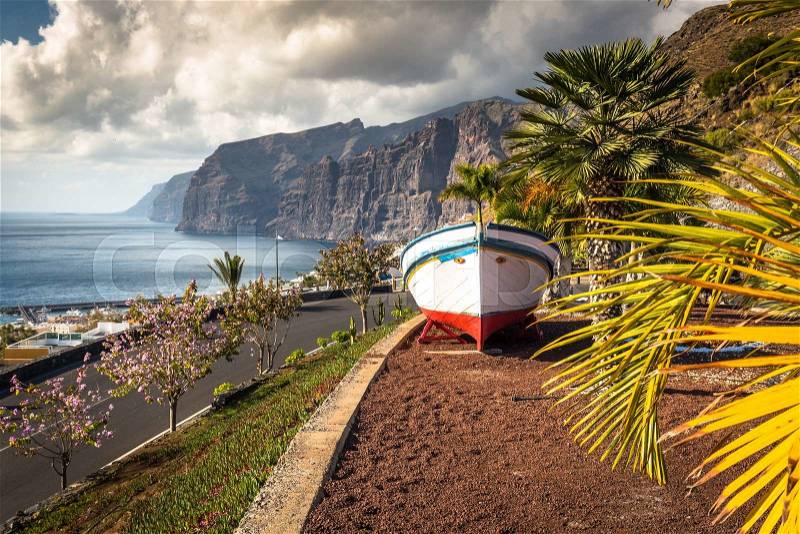 Colourful painted fishing boat near the ocean in Los Gigantes, Tenerife, Canary Islands, a picture postcard scenic view of the island, stock photo