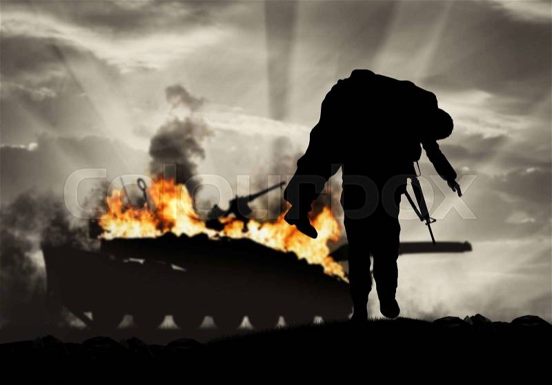Concept of war and conflict. Soldier carries a wounded soldier on a background of a burning tank, stock photo