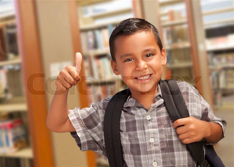 Handsome Hispanic Student Boy with Back Pack and Thumbs Up in the Library, stock photo