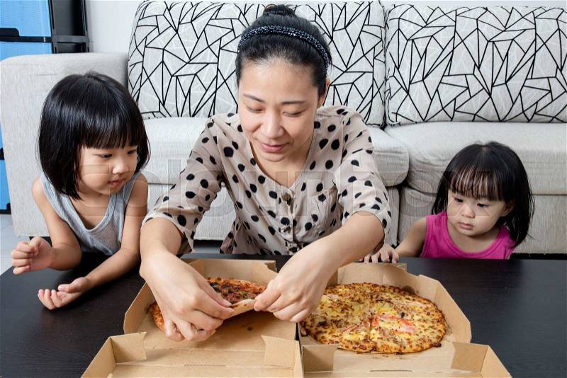 Happy Asian Chinese Family Enjoying Pizza Together at Home, stock photo