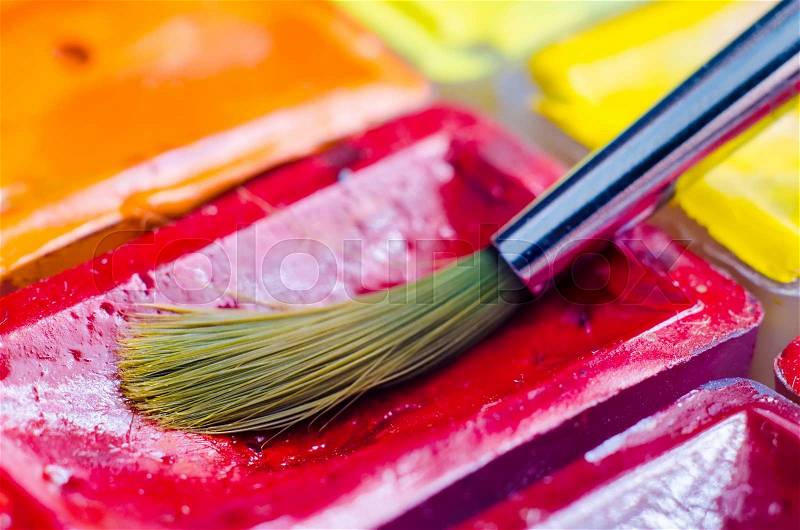 Paint brush with watercolor paints macro, stock photo