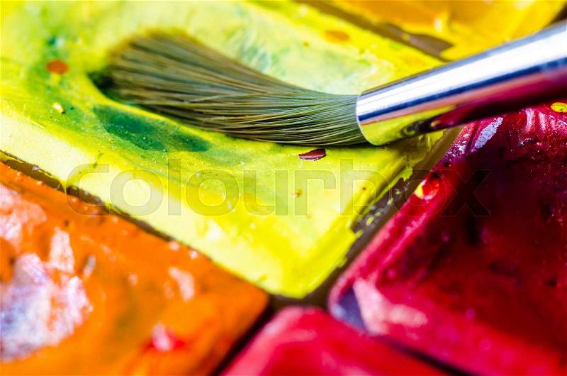 Paint brush with watercolor paints macro, stock photo