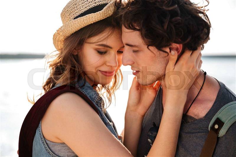 Closeup of tender sensual young couple standing and embracing outdoors, stock photo