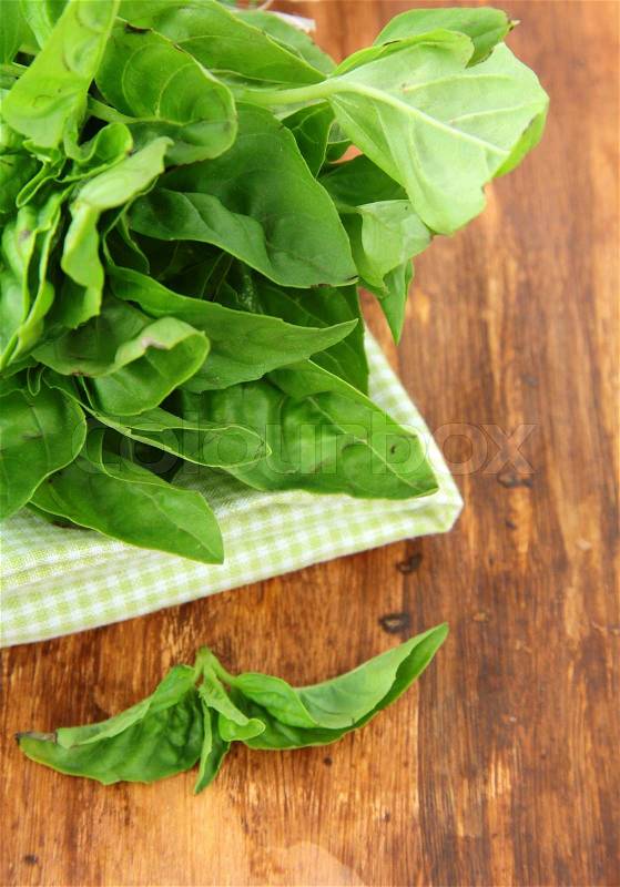 Bunch of fresh basil on a napkin on the table, stock photo