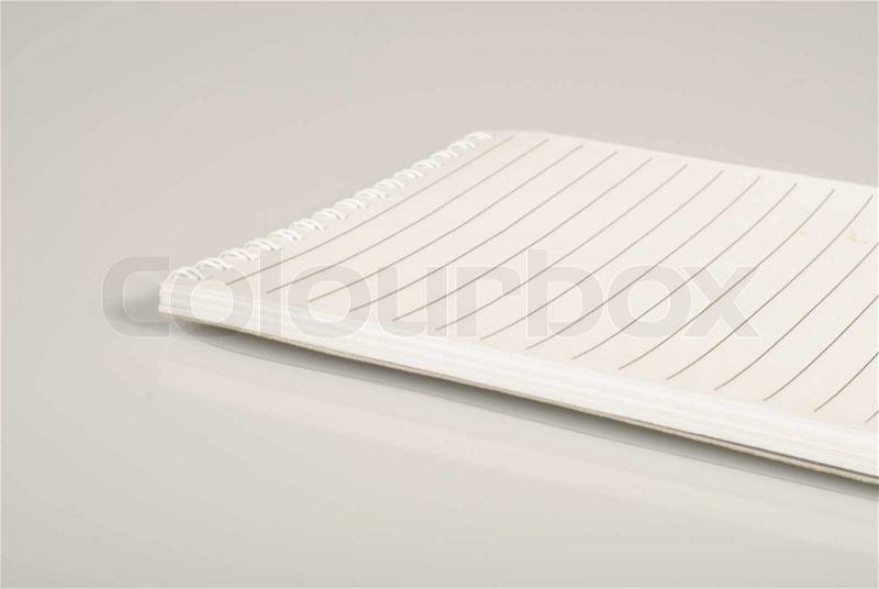 Notebook with white pages and thin lines for your copy text. Isolated, stock photo