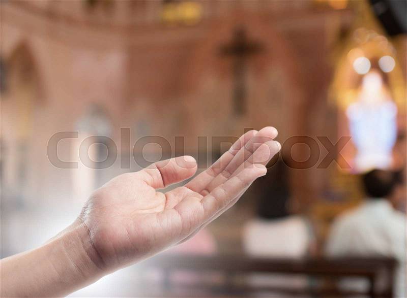 Human open empty hand with palms up(Praying Hand) on blurred church interior background, stock photo