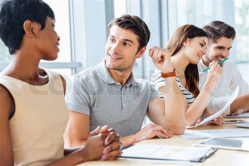 Happy business people talking and working on meeting in office, stock photo