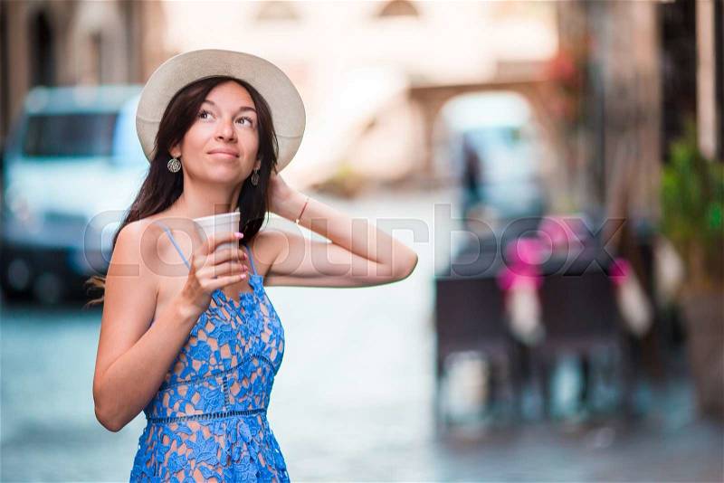 Woman in Rome with coffee to go on vacation travel. Smiling happy caucasian girl having fun laughing on Italian sidewalk cafe during holidays in Rome, Italy, Europe, stock photo